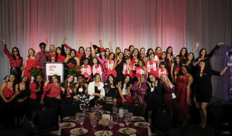 Group photo of Girls Inc. staff members cheering