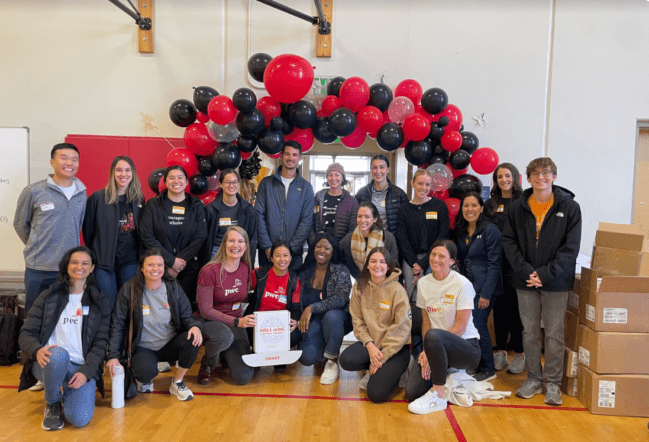 A large group of PwC employees smiling