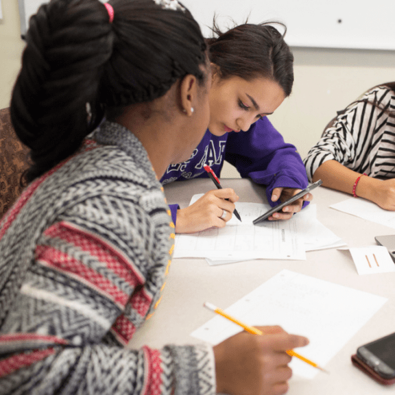 Teen girls studying.