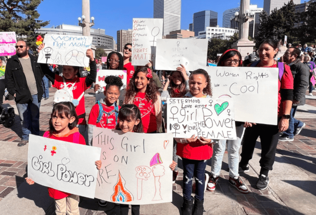 Girls holding womens rights signs